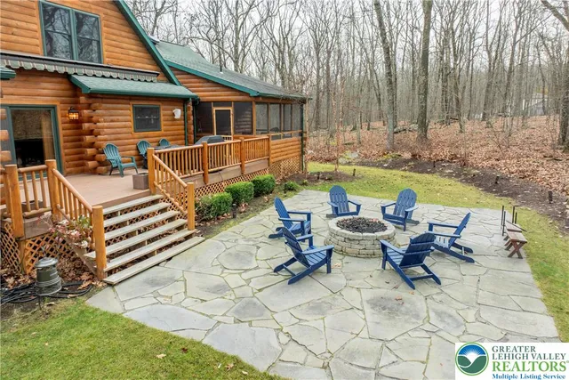 a backyard of a house with table and chairs