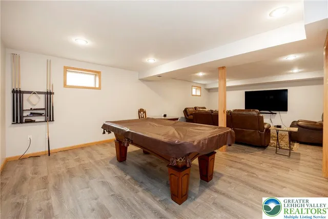 a view of a brick house with large windows and a road