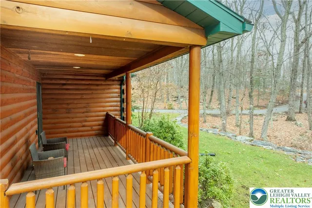 a living room with furniture a fireplace and wooden floor
