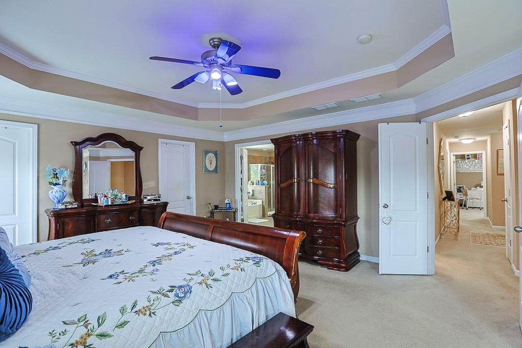 300 Hampton Place Canton, GA 30115 - Photo 60 of 82 a bedroom with a bed dresser and a large mirror