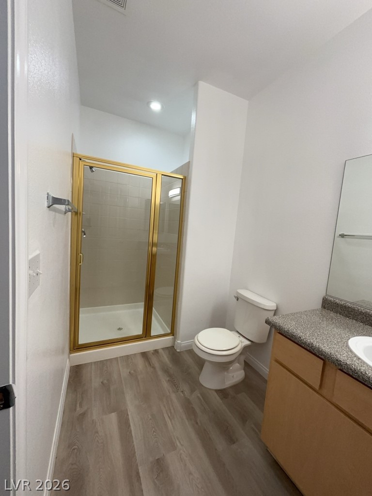 4915 East Russell Road, Unit 144 Las Vegas, NV 89120 - Photo 12 of 14 Bathroom featuring vanity, dark wood-style flooring, and a stall shower