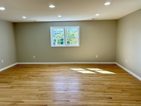 1 Heritage Lane Monson, MA 01057 - Photo 12 of 23 a view of an empty room with wooden floor and a window