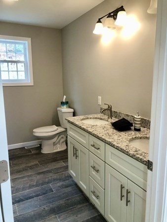 1 Heritage Lane Monson, MA 01057 - Photo 15 of 23 a bathroom with a granite countertop sink a toilet and a window