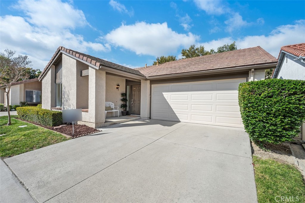 23581 Ribalta Mission Viejo, CA 92692 - Photo 1 of 1 a front view of a house with a yard and garage