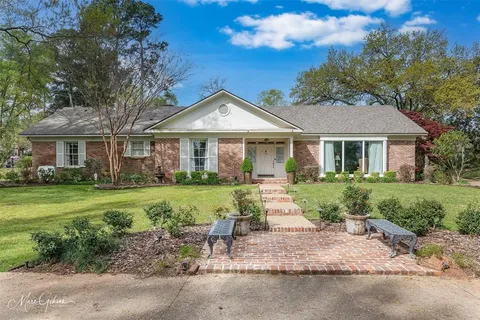 a front view of a house with a yard table and chairs