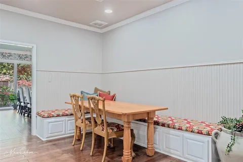 a dining room with furniture and wooden floor