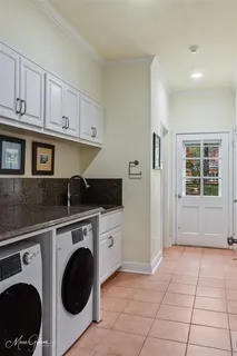 a kitchen with a stove top oven sink and cabinets