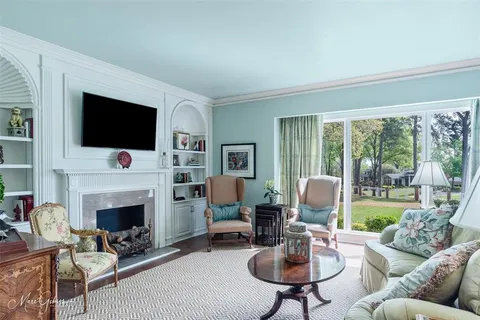 a living room with furniture fireplace and a flat screen tv