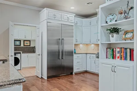 a view of kitchen with cabinet and refrigerator