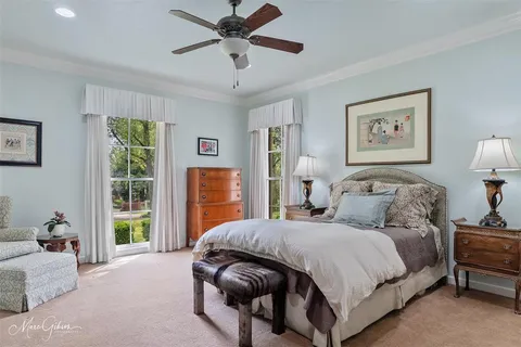 a bedroom with a large bed and a window