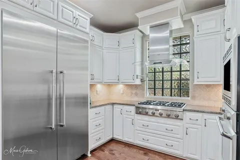 a kitchen with cabinets and appliances