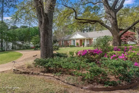a view of a house with a yard and sitting area