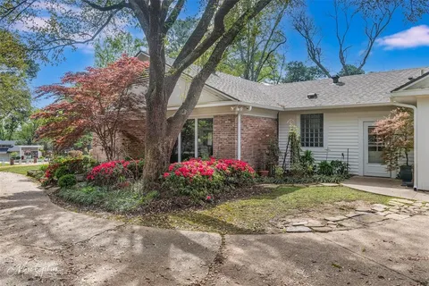 a house view with a sitting space and garden