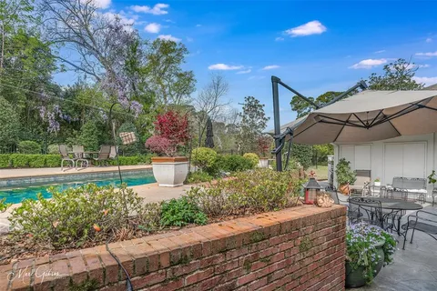 a view of a patio with table and chairs potted plants