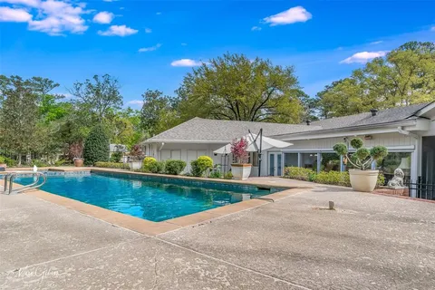 swimming pool with outdoor seating and yard