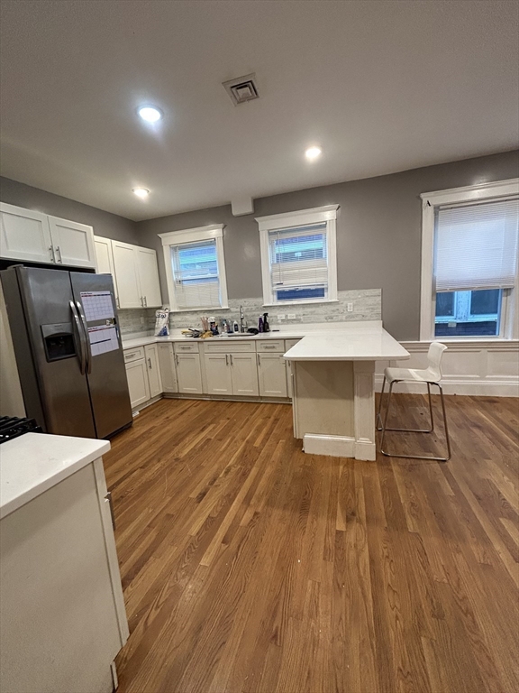 36 Hosmer Street, Unit 2 Boston, MA 02126 - Photo 11 of 30 a large kitchen with a table and chairs