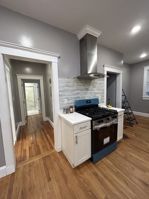 36 Hosmer Street, Unit 2 Boston, MA 02126 - Photo 12 of 30 a kitchen with granite countertop a stove and a wooden floors