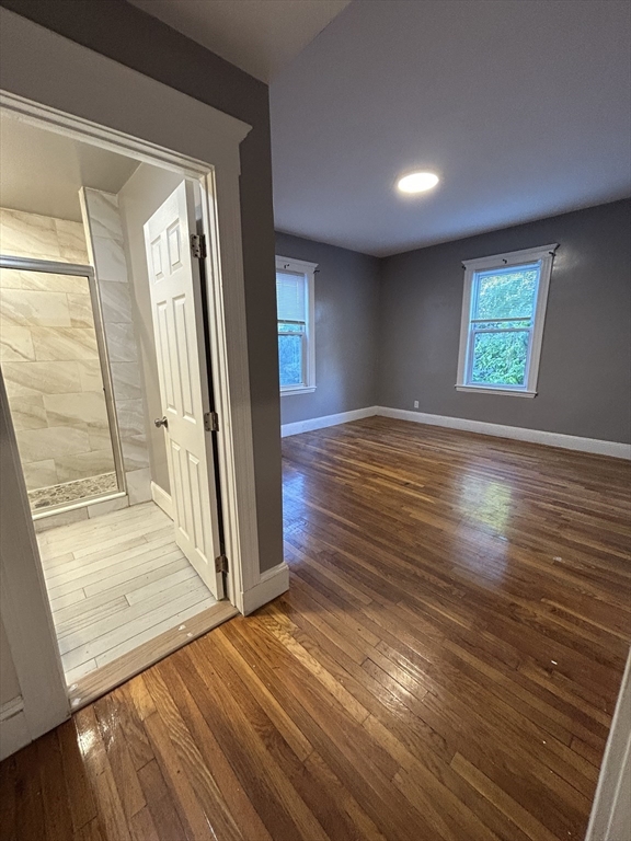 36 Hosmer Street, Unit 2 Boston, MA 02126 - Photo 13 of 30 wooden floor in an empty room with a window