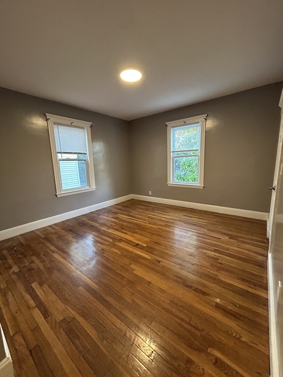 36 Hosmer Street, Unit 2 Boston, MA 02126 - Photo 14 of 30 a view of an empty room with wooden floor and a window