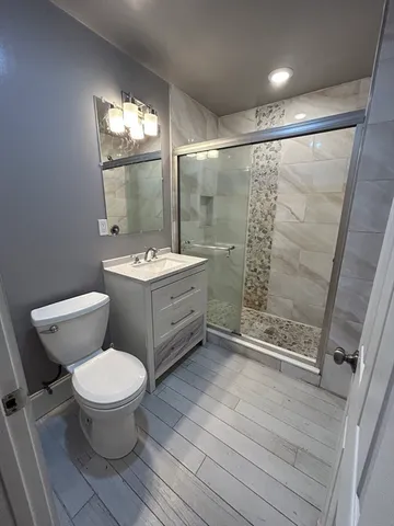 a bathroom with a sink toilet and shower