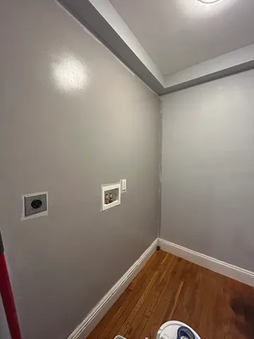 a view of a room with wooden floor