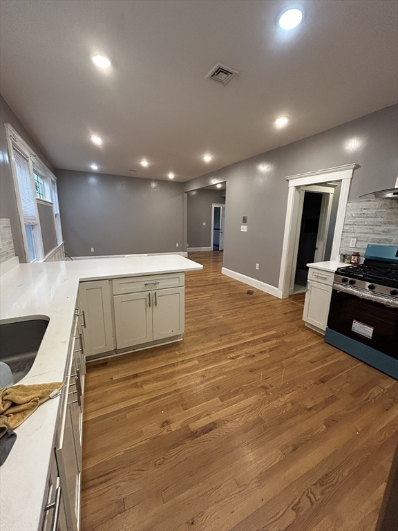 36 Hosmer Street, Unit 2 Boston, MA 02126 - Photo 20 of 30 a large hall with stainless steel appliances a large counter top a stove and a sink