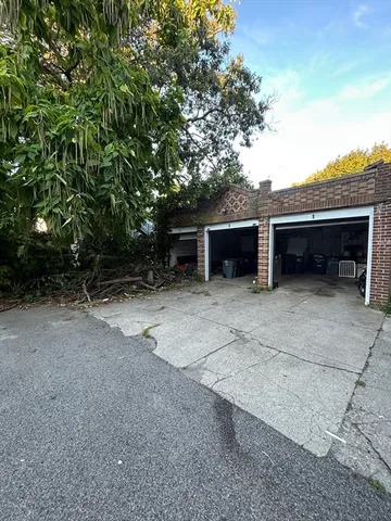 a view of a house with a yard and a garage