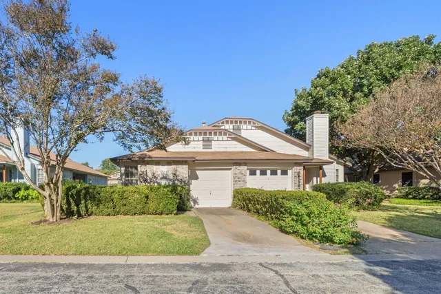 front view of a house with a garden