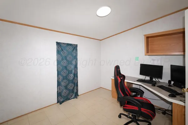 a view of a workspace with furniture and a gate