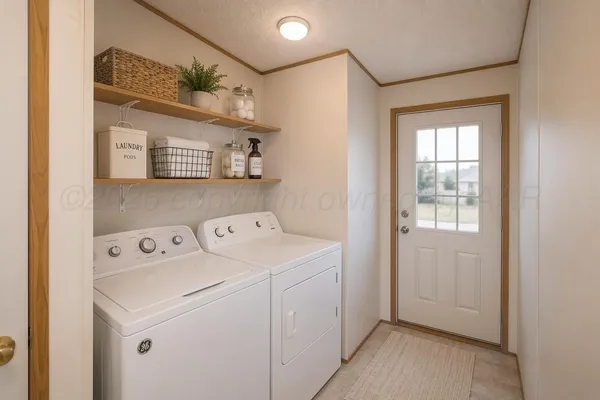 a view of washer and dryer with kitchen in the background