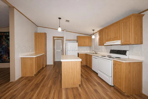 a kitchen with wooden floor and window