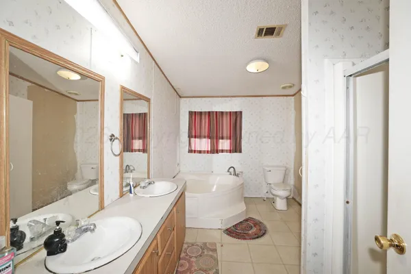 a bathroom with a sink vanity granite and toilet