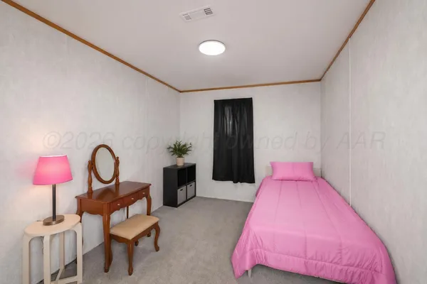 a living room with furniture and a lamp
