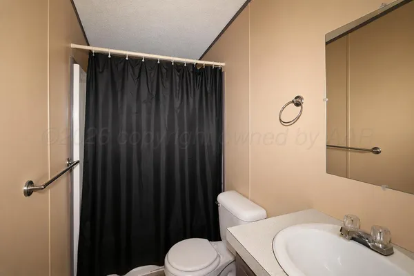 a white toilet sitting next to a bathroom sink