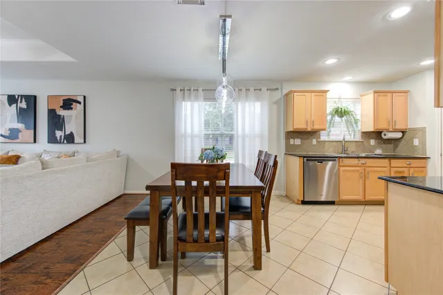 a view of a dining room and chandelier with furniture and window