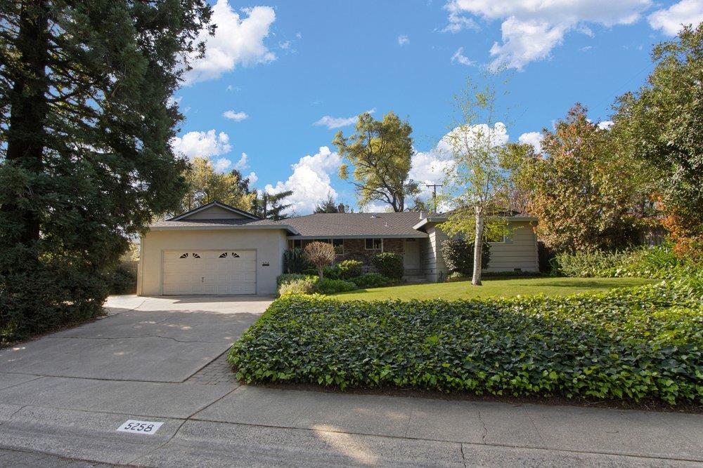 5258 Woodvale Way Carmichael, CA 95608 - Photo 1 of 1 a front view of a house with a yard and garage