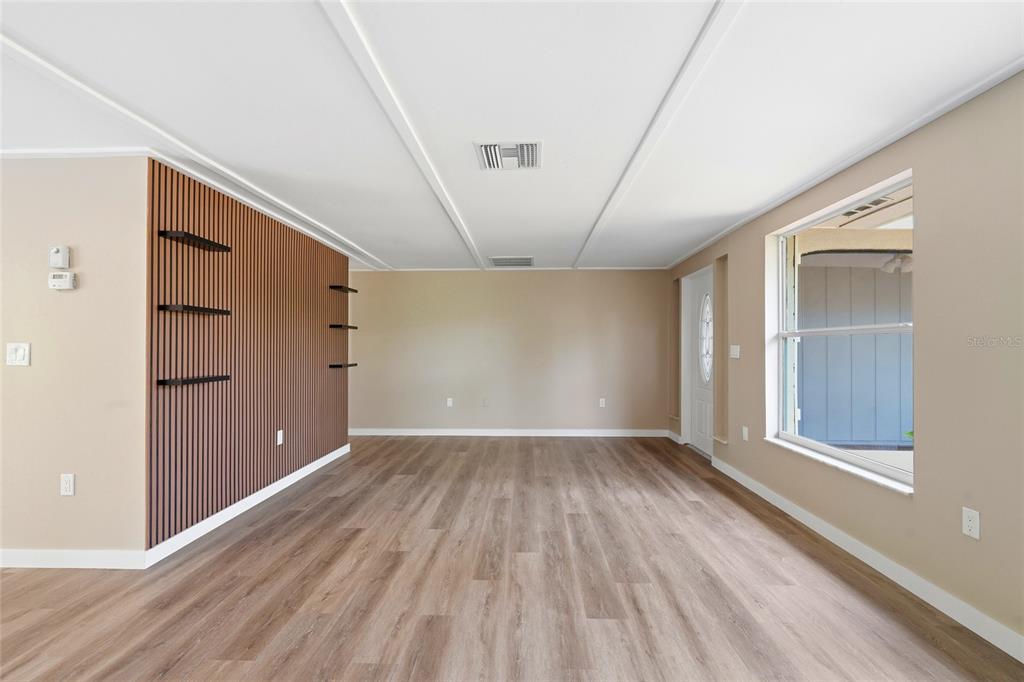 5984 Diana Road Venice, FL 34293 - Photo 8 of 36 wooden floor in an empty room with a window