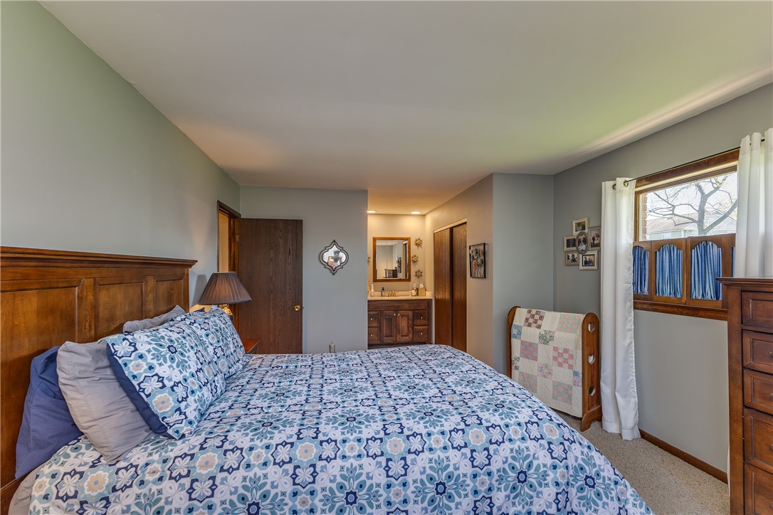 4210 Pleasanton Road Englewood, OH 45322 - Photo 19 of 34 This cozy bedroom features carpeted flooring and a convenient attached bathroom.