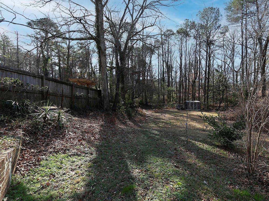 721 Woodvalley Road Southwest Mableton, GA 30126 - Photo 21 of 26 a backyard of a house with lots of green space