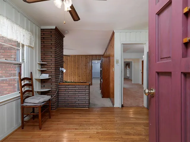 a view of a hallway with seating area