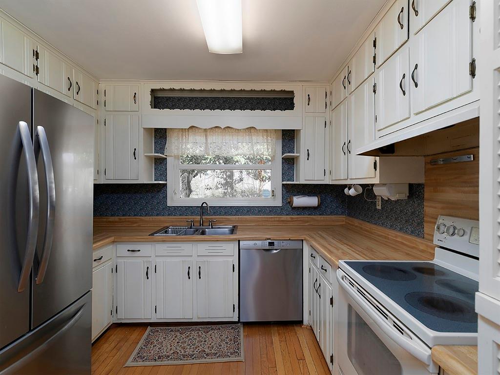 721 Woodvalley Road Southwest Mableton, GA 30126 - Photo 4 of 26 a kitchen with stainless steel appliances a sink a stove a refrigerator and cabinets