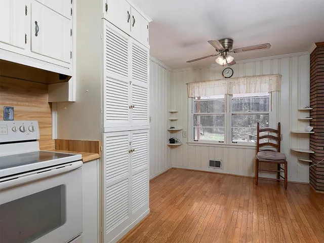 a view of workspace with wooden floor and ceiling fan