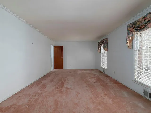 a view of an empty room and a window