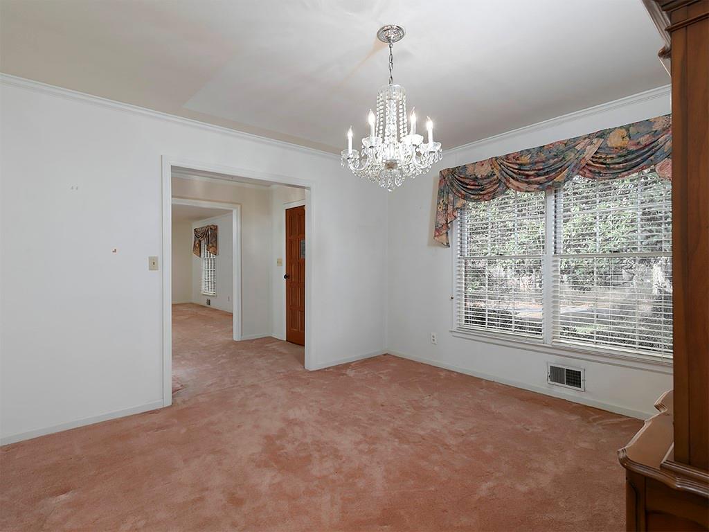 721 Woodvalley Road Southwest Mableton, GA 30126 - Photo 10 of 26 a view of a livingroom with a chandelier curtains and large windows
