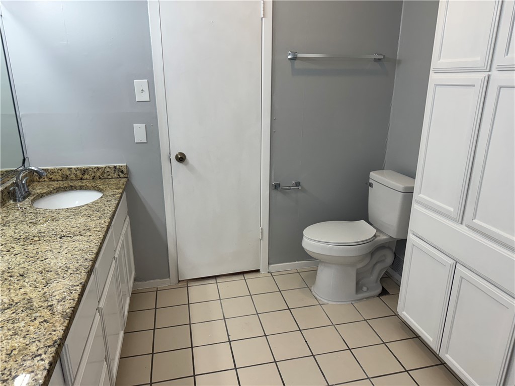 5518 Kenith Circle Corpus Christi, TX 78413 - Photo 11 of 21 a bathroom with a granite countertop sink and a toilet