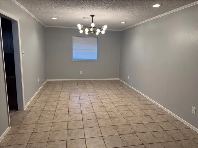a view of an empty room with a chandelier