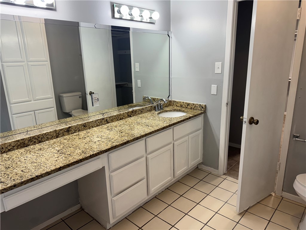 5518 Kenith Circle Corpus Christi, TX 78413 - Photo 10 of 21 a bathroom with a granite countertop sink and a mirror