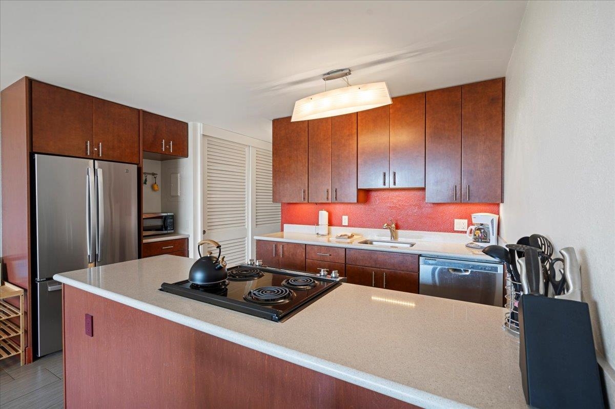 2191 South Kihei Road, Unit 2303 Kihei, HI 96753 - Photo 18 of 43 a kitchen with stainless steel appliances a sink a stove and a refrigerator