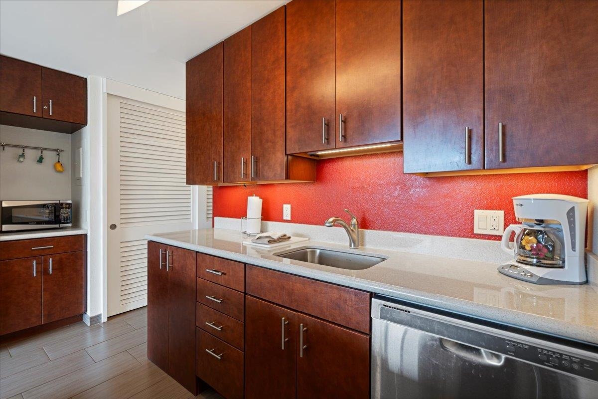 2191 South Kihei Road, Unit 2303 Kihei, HI 96753 - Photo 21 of 43 a kitchen with stainless steel appliances granite countertop a sink a stove cabinets and wooden floor