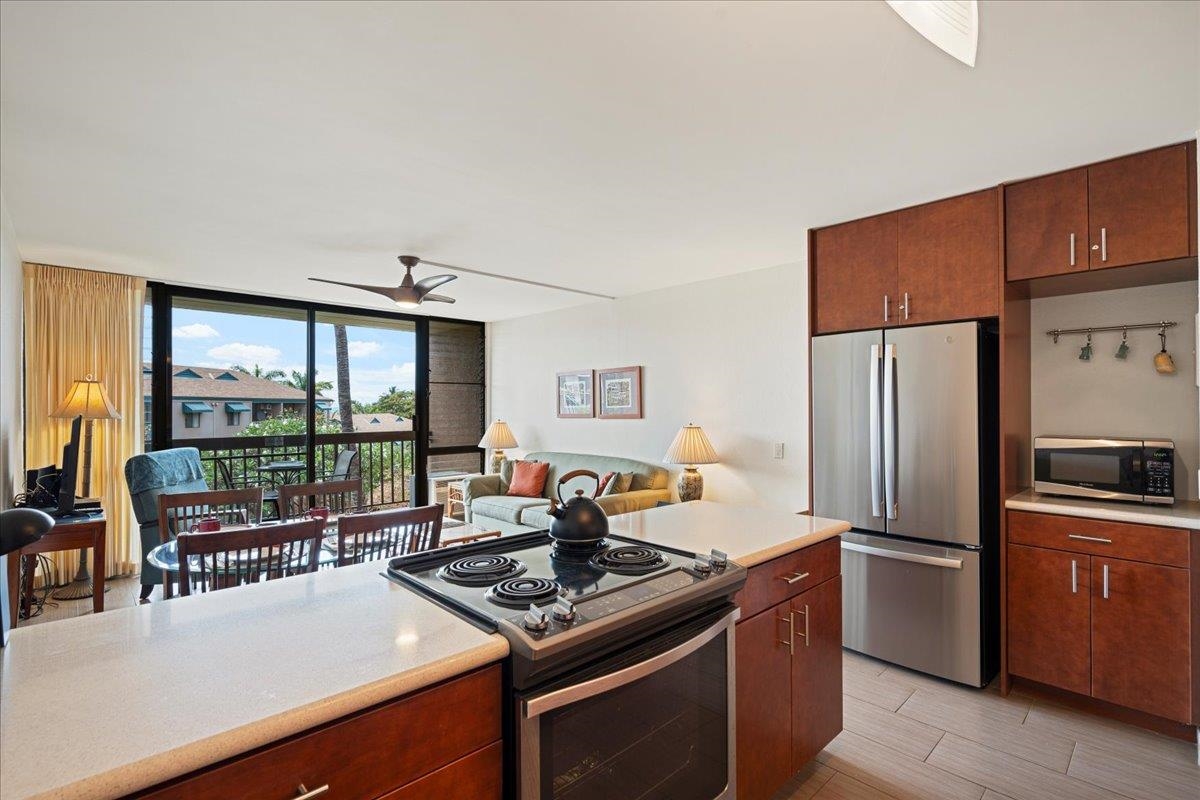 2191 South Kihei Road, Unit 2303 Kihei, HI 96753 - Photo 23 of 43 a kitchen with stainless steel appliances granite countertop a stove a refrigerator and a stove